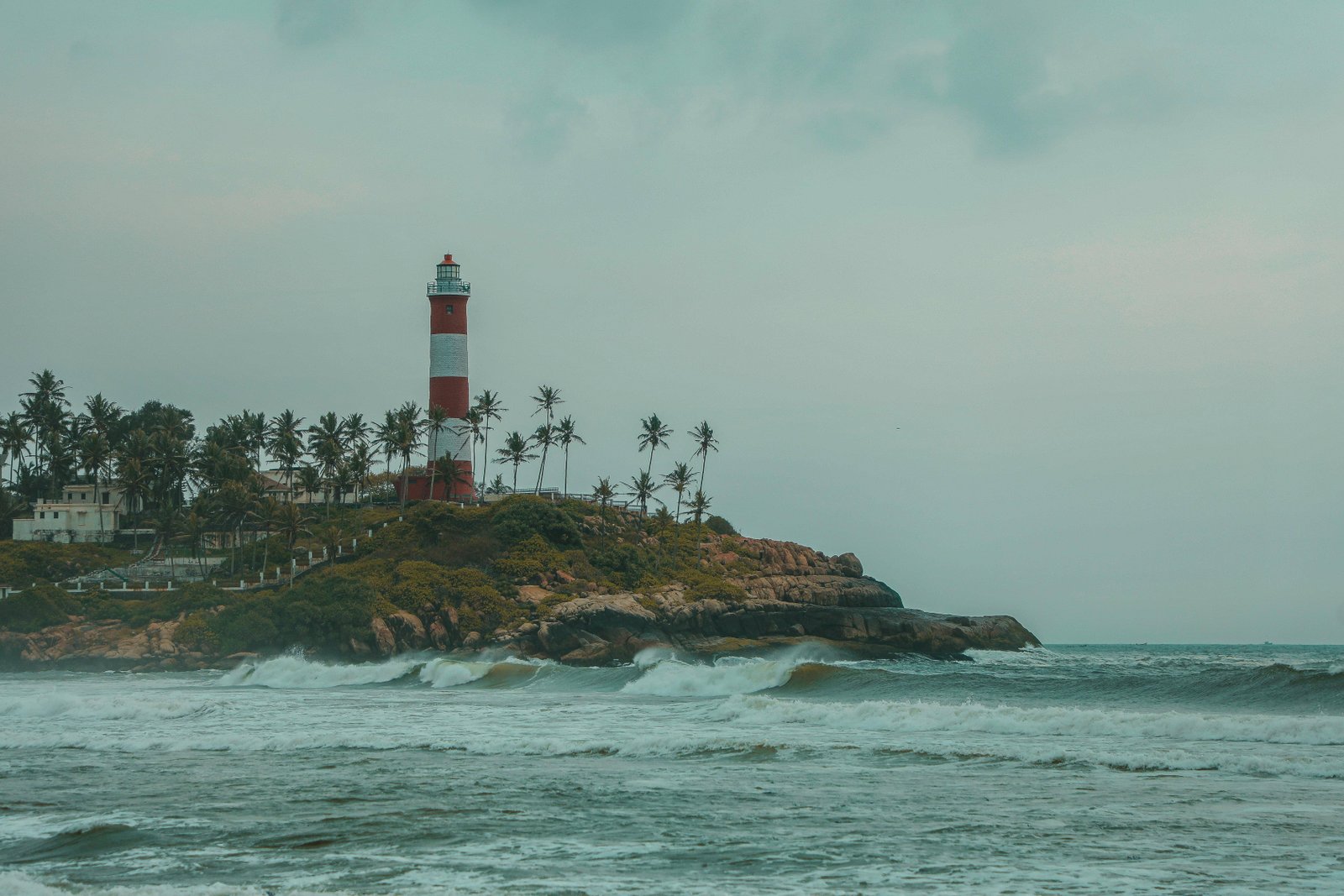Lighthouse beach, palm-fringed shores, and vibrant local life in Kovalam, Kerala, India tour